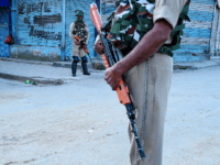 Security personnel stand guard in front of closed shops in Srinagar on August 23, 2019. - An Indian soldier was killed by Pakistani forces on the Kashmir border, the military said on August 23, as a tense lockdown in the region of seven million residents continued for the 19th day. …