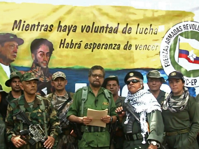 This TV grab taken from youtube and released on August 29, 2019 shows former senior commander Ivan Marquez(C) and fugitive rebel colleague, Jesus Santrich(wearing sunglass), of the dissolved FARC rebel army group in Colombia, on an undisclosed location of Colombia announcing that they are taking up arms again along with …