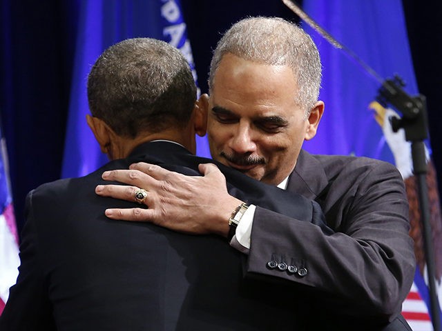 Outgoing Attorney General Eric Holder (R) hugs US President Barack Obama at the portrait unveiling ceremony for at the Justice Department in Washington, DC on February 27, 2015. The event marks Holder's anticipated departure after more than six years of service. AFP PHOTO/ YURI GRIPAS (Photo credit should read YURI …