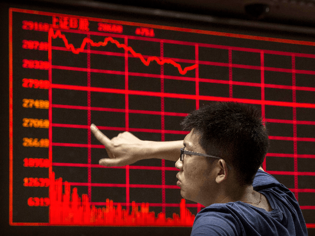 A Chinese day trader reacts as he watches a stock ticker at a local brokerage house on Aug