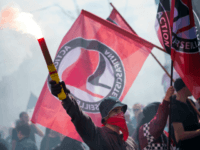 People hold flags of anarchist party reading "Antifacist" as they demonstrate during a May Day rally on May 1, 2014 in Marseille, southern France. AFP PHOTO / BERTRAND LANGLOIS (Photo credit should read BERTRAND LANGLOIS/AFP/Getty Images)