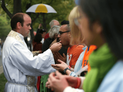 Members of the congregation receive communion during the mass for the conclusion of the World Meeting of Families on Benjamin Franklin Parkway September 27, 2015 in Philadelphia, Pennsylvania. Pope Francis will end his six-day visit to the U.S. after the event. (Photo by Alex Wong/Getty Images)