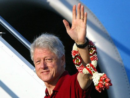 PHUKET, THAILAND: Former US president Bill Clinton waves as he walks up to the private pla