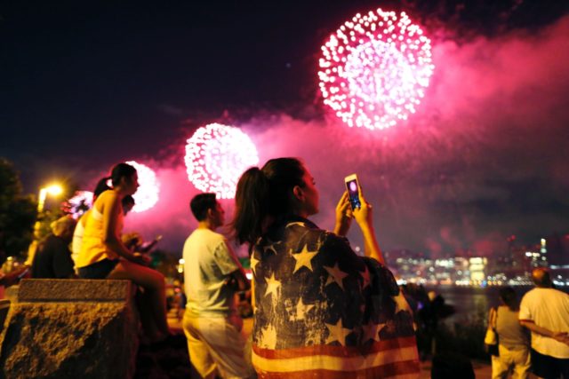 People watch the Macy's 4th of July fireworks show from Queens, New York on July 4, 2