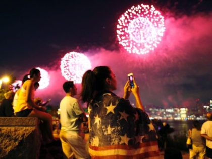 People watch the Macy's 4th of July fireworks show from Queens, New York on July 4, 2