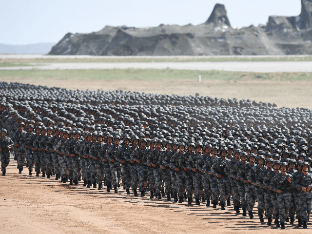 Chinese soldiers march in a military parade at the Zhurihe training base in China's northe