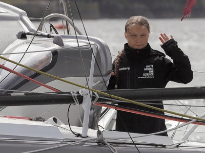 Swedish climate activist Greta Thunberg waves from aboard the Malizia II IMOCA class sailing yacht, off the coast of Plymouth, southwest England, on August 14, 2019, as she prepares to start her journey across the Atlantic to New York where she will attend the UN Climate Action Summit next month. …