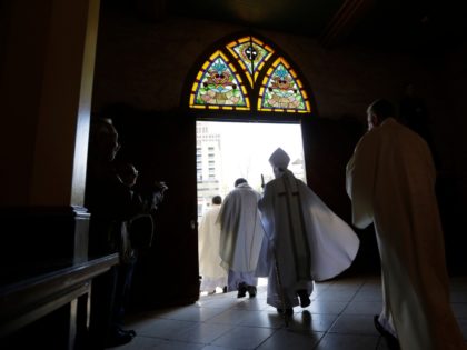 San Antonio Archbishop Gustavo García-Siller leaves San Fernando Cathedral in a procession following a noon Mass, Wednesday, Feb. 11, 2015, in San Antonio. San Fernando is one of the oldest active cathedrals in the United States. (AP Photo/Eric Gay)