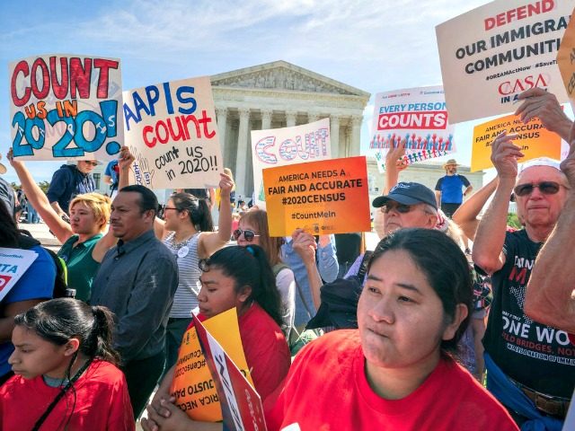 Immigration activists rally outside the Supreme Court as the justices hear arguments over