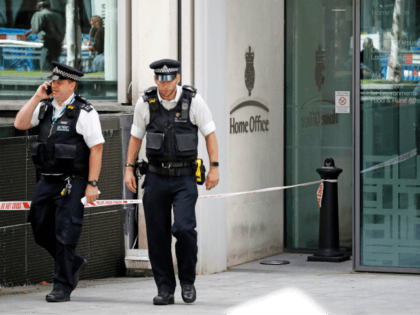 British Police officers leave the entrance to Britain's Home Office in central London on A