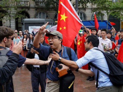 Protestors gathering to support Pro-democracy demonstrations in Hong Kong face Counter-protesters waving Chinese flags in the Place Saint Michel, central Paris, on August 17, 2019. - Ten weeks of protests in Hong-Kong have plunged the city into crisis and prompted mainland China to take a more hardline tone. (Photo by …