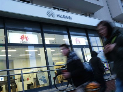 BERLIN, GERMANY - MARCH 12: People walk past a Huawei customer service center on March 12,