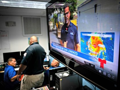 Emergency Center personnel stand next to a tv screen showing a meteorological image of the tropical storm Dorian, as they await its arrival, in Ceiba, Puerto Rico, Wednesday, Aug. 28, 2019. Puerto Rico is facing its first major test of emergency preparedness since the 2017 devastation of Hurricane Maria as …