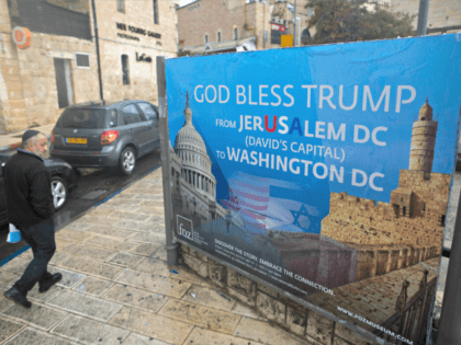 JERUSALEM, ISRAEL - DECEMBER 06: (ISRAEL OUT) An Ultra Orthodox Jewish man walks next to a poster blessing U.S President Donald Trump in downtown on December 6, 2017 in Jerusalem, Israel. U.S. President Donald Trump will announce his recognition of Jerusalem as Israel's capital on Wednesday. (Photo by Lior Mizrahi/Getty …