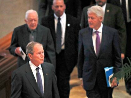 Former President George Bush is followed by former Presidents Jimmy Carter and Bill Clinto