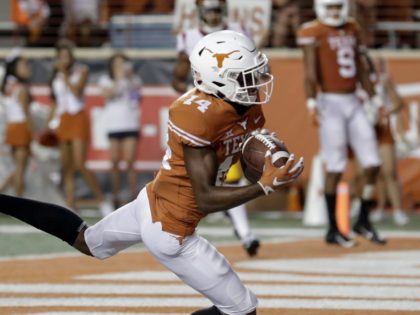 AUSTIN, TX - SEPTEMBER 15: Joshua Moore #14 of the Texas Longhorns catches a pass for a touchdown in the third quarter defended by Ajene Harris #27 of the USC Trojans at Darrell K Royal-Texas Memorial Stadium on September 15, 2018 in Austin, Texas. (Photo by Tim Warner/Getty Images)