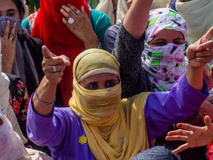 SRINAGAR, KASHMIR, INDIA - AUGUST 23: Kashmiri Muslims women shout anti Indian slogans during an anti Indian protest, on August 23, 2019 in Srinagar, the summer capital of Indian administered Kashmir, India. Indian authorities have deployed its thousands of government forces in Kashmir for the last three weeks after India …