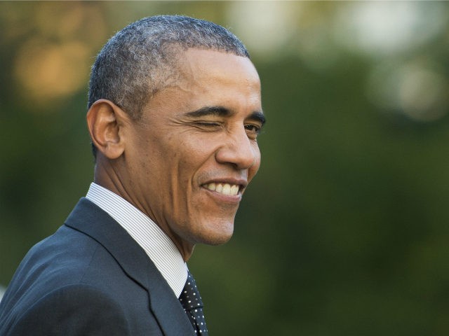 US President Barack Obama winks at the press as he prepares to depart the White House in W