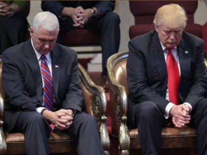 Republican presidential nominee Donald Trump (R) and running mate Mike Pence bow their heads in prayer during the Midwest Vision and Values Pastors and Leadership Conference at the New Spirit Revival Center in Cleveland Heights, Ohio on September 21, 2016. / AFP PHOTO / MANDEL NGAN (Photo credit should read …