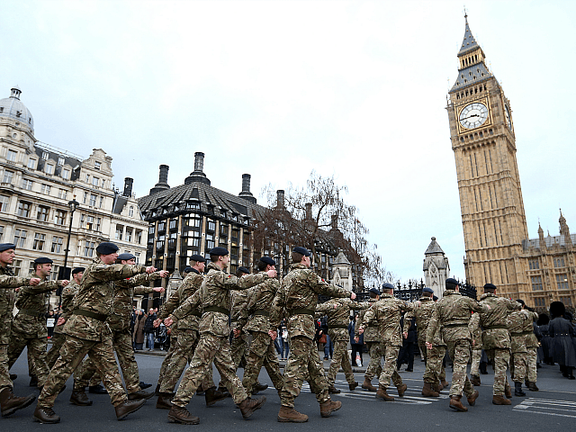 LONDON, ENGLAND - JANUARY 26: Military personnel march into the Houses of Parliament on Ja