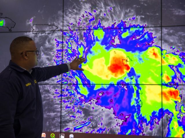 Workers of the Emergency Operation Centre (COE) monitor Tropical Storm Dorian in Santo Dom