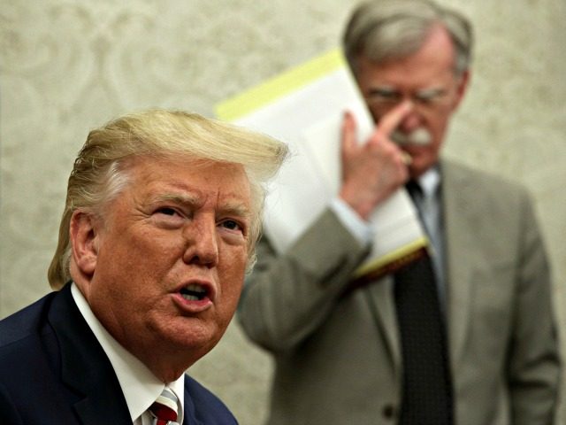WASHINGTON, DC - AUGUST 20: U.S. President Donald Trump speaks to members of the media as National Security Adviser John Bolton listens during a meeting with President of Romania Klaus Iohannis in the Oval Office of the White House August 20, 2019 in Washington, DC. This is Iohannis’ second visit …