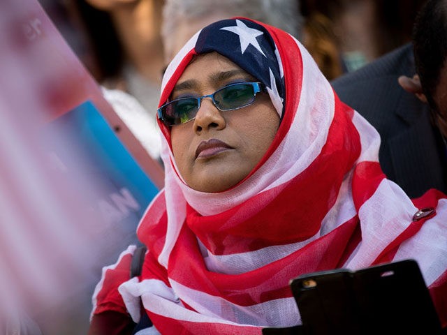 WASHINGTON, DC - OCTOBER 18: A woman wears an American flag themed hijab as she attends a protest against the Trump administration's proposed travel ban, October 18, 2017 in Washington, DC. Early Wednesday morning, a federal judge in Maryland granted a motion for a preliminary injunction on the administration's travel …