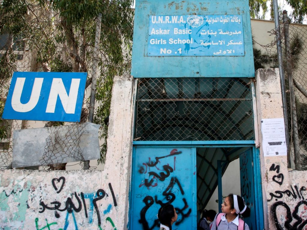 Palestinian girls exit from a school run by the United nations Relief and Works Agency's (UNRWA, UN agency for Palestinian refugees), in the Askar refugee camp east of Nablus in the occupied West Bank on September 2, 2018. - The United States, the biggest contributor to the UNRWA -- a lifeline for millions of Palestinians for over 70 years, announced on August 31 it was halting its funding to the organisation, which it labelled "irredeemably flawed". (Photo by Jaafar ASHTIYEH / AFP) (Photo credit should read JAAFAR ASHTIYEH/AFP/Getty Images)