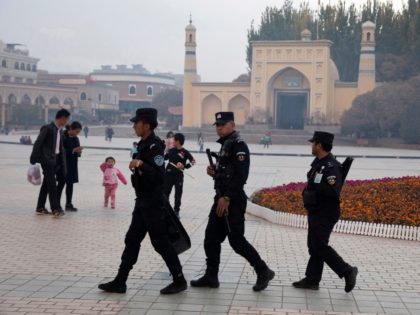 FILE - In this Nov. 4, 2017 file photo, Uighur security personnel patrol near the Id Kah Mosque in Kashgar in western China's Xinjiang region. China's northwestern region of Xinjiang has revised legislation to allow the detention of suspected extremists in "education and training centers." The revisions come amid rising …