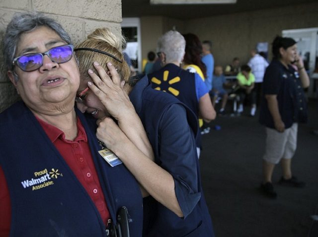 Distraught Walmart employees outside the scene of a shooting that left 20 dead and 26 injured. (Mark Lambie/The El Paso Times via AP)