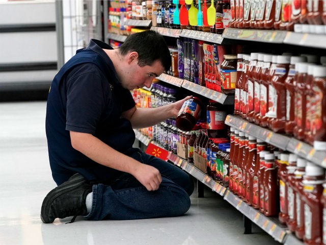 In this Nov. 9, 2018, file photo a Walmart associate stocks a shelf at a Walmart Supercent