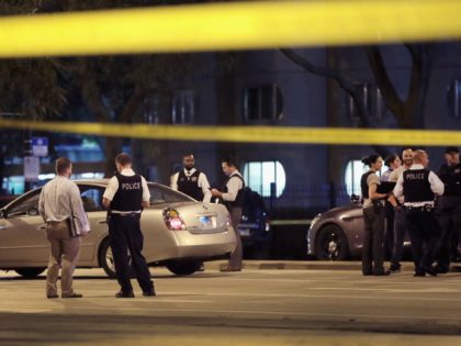 CHICAGO, IL - SEPTEMBER 19: Police investigate the scene of a shooting near the Chinatown