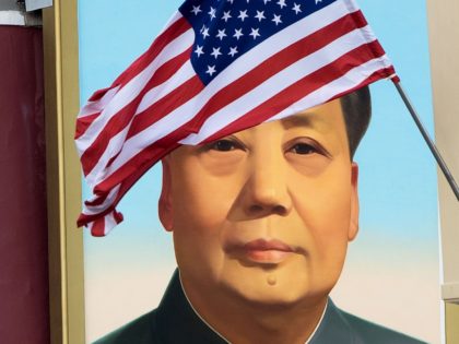 A US flag is displayed in front of the portrait of China's late communist leader Mao Zedong outside the Forbidden City in Beijing on November 8, 2017. US President Donald Trump toured the Forbidden City with Chinese leader Xi Jinping on November 8 as he began the crucial leg of …