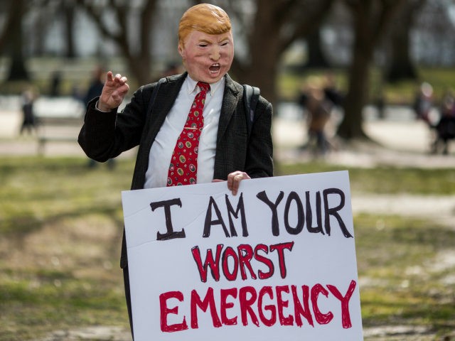 A demonstrator wearing a mask depicting President Donald Trump stands in Lafayette Square during a demonstration organized by the American Civil Liberties Union (ACLU) protesting President Donald Trump's declaration of emergency powers on February 18, 2019 in Washington, DC. (Photo by Zach Gibson/Getty Images)