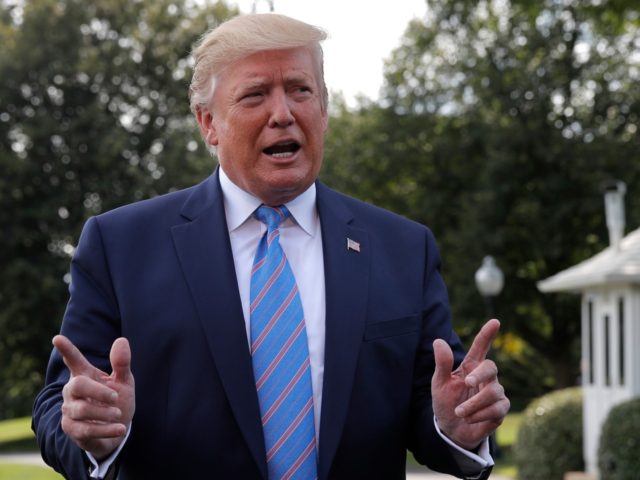 President Donald Trump stops to speak to reporters before departing the White House in Was