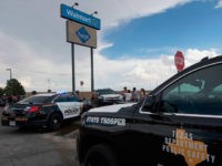 Police and state troopers keep watch outside the Cielo Vista Mall Wal-Mart (background) where a shooting left 20 people dead in El Paso, Texas, on August 4, 2019. - A shooting at a Walmart store in Texas left multiple people dead. At least one suspect was taken into custody after …
