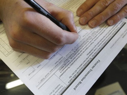OREM, UT - FEBRUARY 15: A man fills out a federal background check form at Good Guys Guns