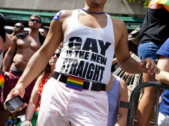 NEW YORK - JUNE 24: A man wears a shirt that reads "gay is the new straight" during the Ne