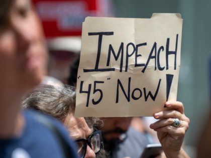 NEW YORK, NY - JUNE 15: A protestor holds a sign calling for the impeachment of U.S. President Donald Trump during a demonstration on June 15, 2019 in New York City. Major cities across the country are expected to hold "#ImpeachTrump Day of Action" protests on Saturday to demand that …