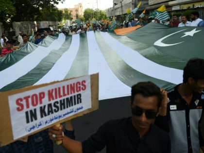 TOPSHOT - Demonstrators hold a giant flag of Pakistan-administered Kashmir during an anti-Indian protest in Karachi on August 18, 2019. - Tensions have soared since India earlier this month stripped the part of Kashmir that it controls of its autonomy, sparking calls from Pakistan for the international community to intervene …