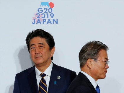 South Korean President Moon Jae-In (R) walks after he was greeted by Japanese Prime Minister Shinzo Abe prior to a family photo session at the G20 Summit in Osaka on June 28, 2019. (Photo by KIM KYUNG-HOON / POOL / AFP) (Photo credit should read KIM KYUNG-HOON/AFP/Getty Images)