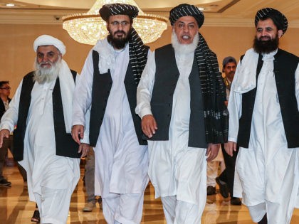 Mohammad Nabi Omari (C-L), a Taliban member formerly held by the US at Guantanamo Bay and reportedly released in 2014 in a prisoner exchange, Taliban negotiator Abbas Stanikzai (C-R), and former Taliban intelligence deputy Mawlawi Abdul Haq Wasiq (R) walk with another Taliban member during the second day of the …