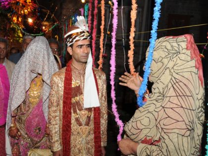Kashmiri groom and bride in traditional attire walk their "Yanivol" or wedding day in Srin