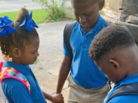 Jamisha Harris shared a photo of her children Eugene Jacobs, 10, Jorden Jacobs, 8, and Emily Jacobs, 7, praying before their first day of school. (Courtesy of Jamisha Harris)