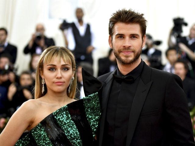 Miley Cyrus, left, and Liam Hemsworth attend The Metropolitan Museum of Art's Costume