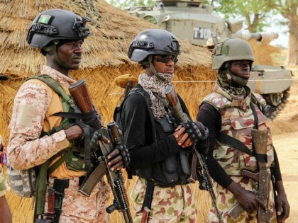 Nigerian Army soldiers stand at a base in Baga on August 2, 2019. - Intense fighting between a regional force and the Islamic State group in West Africa (ISWAP) has resulted in dozens of deaths, including at least 25 soldiers and more than 40 jihadists, in northeastern Nigeria. ISWAP broke …