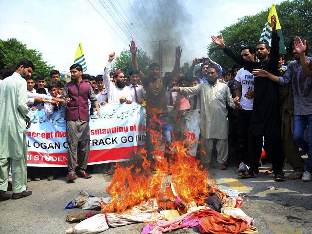 Pakistani Kashmiris burn effigies of Indian leaders at a protest in Muzaffarabad, Pakistan