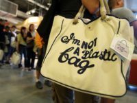 NEW YORK - JULY 18: Customers stand in line after purchasing the "I'm Not a Plastic Bag" shopping totes by Anya Hindmarch at a Whole Foods Market July 18, 2007 in New York City. 20,000 of the environmentally-friendly bags went on sale for $15 each at 8:00 a.m. this morning. …