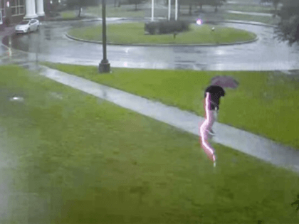 Video captures the moment when Romulus McNeill stepped outside during a storm, when a flash of lighting struck so close by that he dropped his umbrella before getting out of there.
