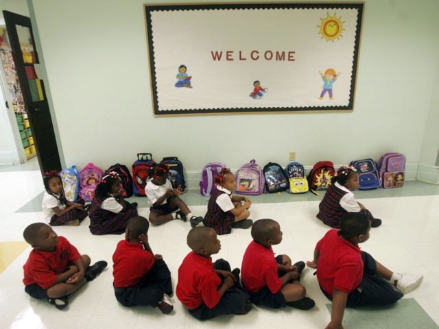 NEW ORLEANS - AUGUST 24: Kindergarten students sit in a hallway on their third day of school in the Benjamin Franklin Elementary Mathematics and Science School August 24, 2006 in New Orleans, Louisiana. Fall classes have already begun in certain parts of the city. (Photo by Mario Tama/Getty Images)